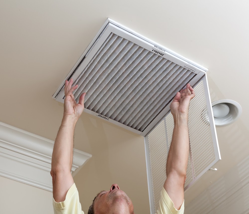 Man correctly installing an air vent