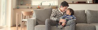Father and son on couch