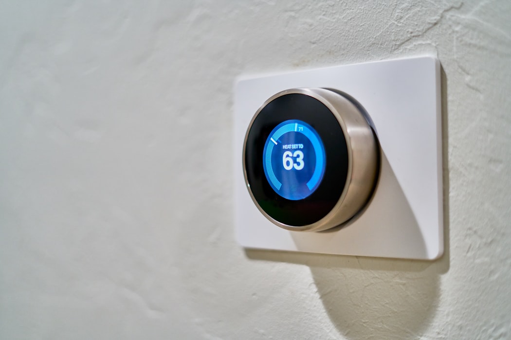 A smart thermostat mounted on a wall